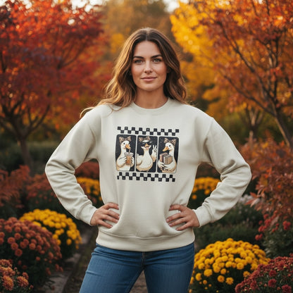 Between The Pages Boutique cream crewneck sweatshirt featuring a playful duck graphic with a checkered border